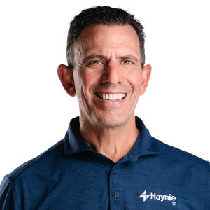 Haynie IT employee smiling in a blue polo shirt with company logo.